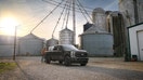 A Ford Super Duty Carhartt edition pickup truck is parked near agricultural silos. - Fox Business News