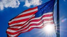 The sun flares below the U.S. flag on the National Mall on April 18, 2024, in Washington, D.C.  - Fox Business News