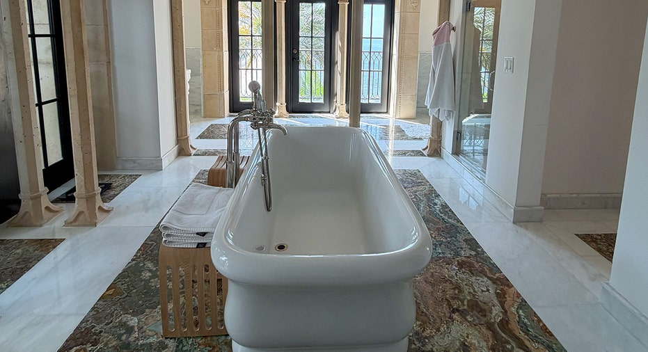 Soaking tub in marble bathroom