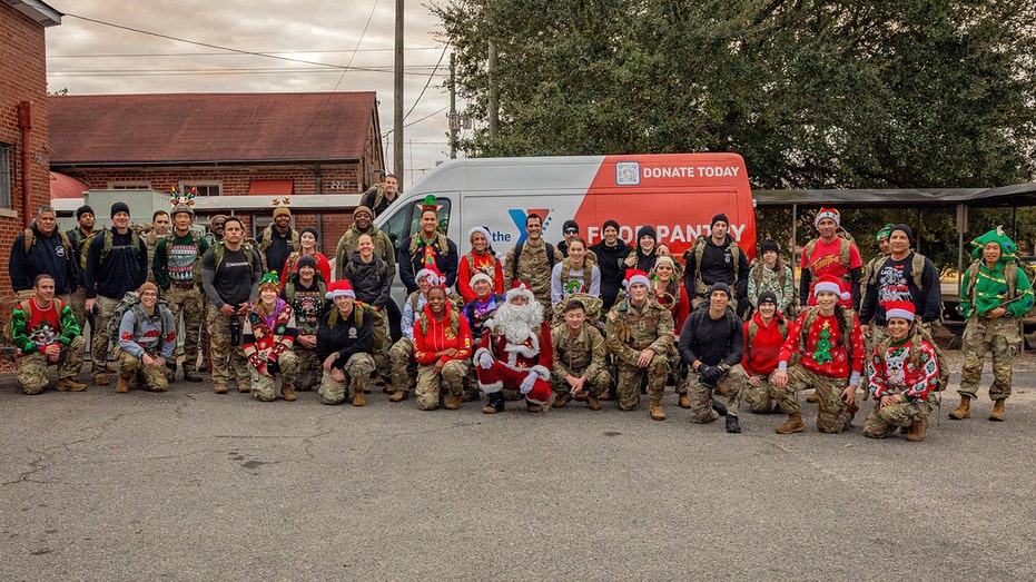 ASYMCA and Members of the 1st Special Forces Command show off Christmas Toy/Food drive