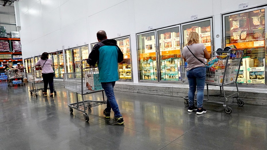 Customers shop at a Costco frozen food aisle