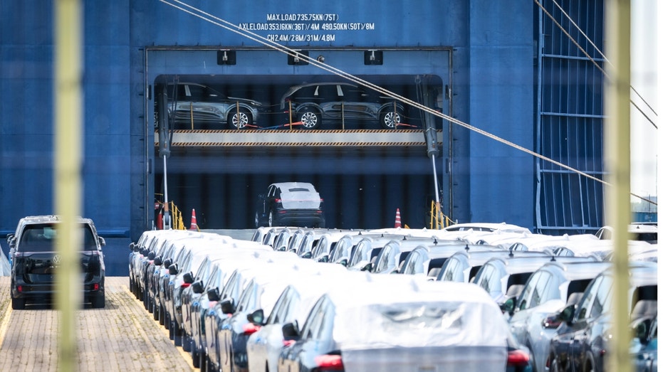 Rows of cars sitting on a carrier ship