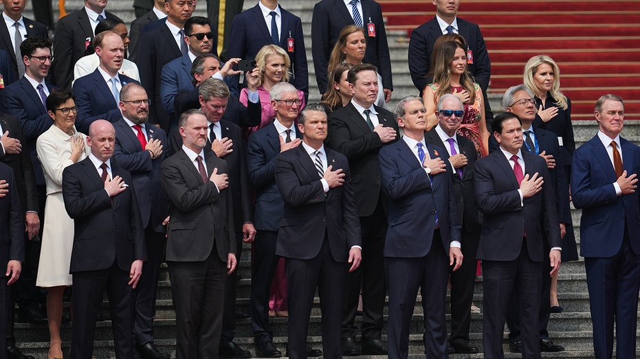 Members of the U.S. delegation and CEOs from various industries stand prior to a welcome ceremony for U.S. President Donald Trump outside the Great Hall