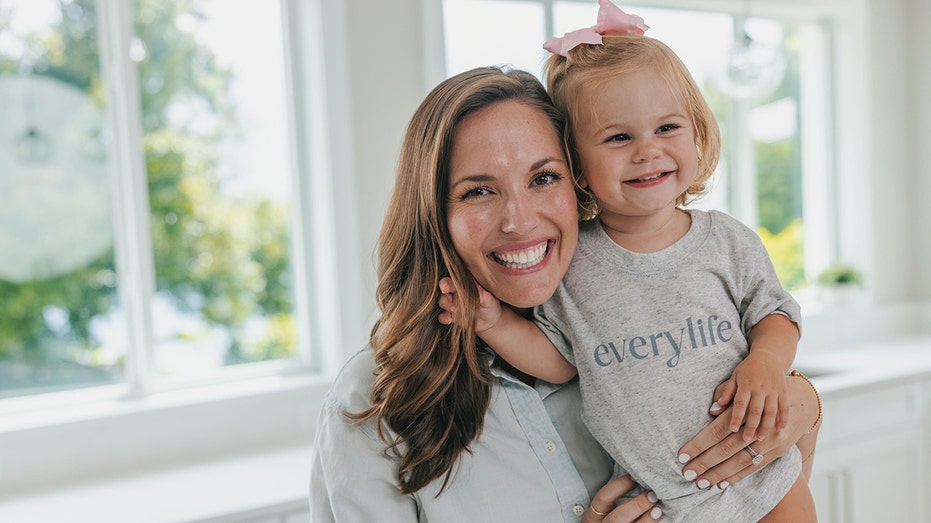 Sarah Gabel Seifert holding a smiling young child