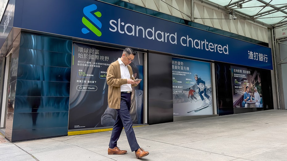 A man outside a Standard Chartered office