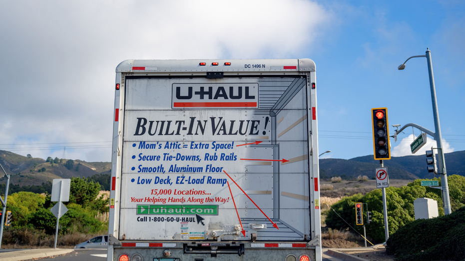 Rear view of U-Haul moving truck stopped at a red light near Hillside Blvd with hills in the background, South San Francisco, California, October 16, 2025.
