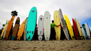 Surfers lined up with their surfboards in San Diego, California - Fox Business News
