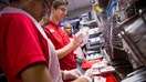 Employees prepare fried chicken sandwiches for guests during an event ahead of the grand opening for a Chick-fil-A restaurant in New York. - Fox Business News