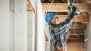 An electrician works on electrical wiring system installation in new home (stock photo). - Fox Business News