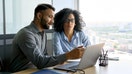 People review tax forms on a laptop computer. - Fox Business News