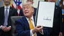 U.S. President Donald Trump shows an executive order he signed in the Oval Office of the White House on June 22, 2026 in Washington, DC. President Trump signed two orders on quantum computing. - Fox Business News