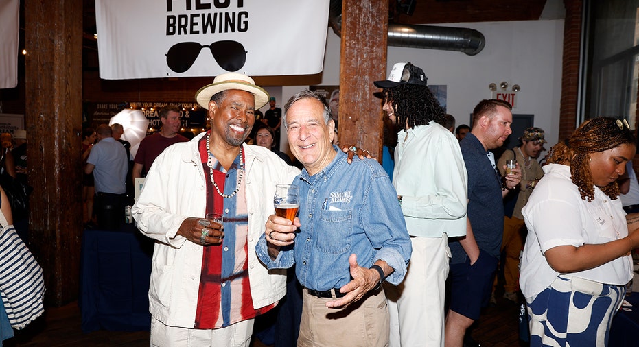 Samuel Adams founder Jim Koch poses with an attendee during the Crafting Dreams Beer Bash in Brooklyn, New York, on June 11, 2026.