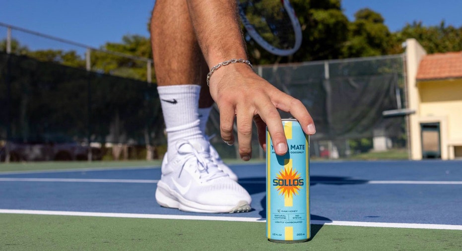 A can of SOLLOS Yerba Mate is displayed on a tennis court.
