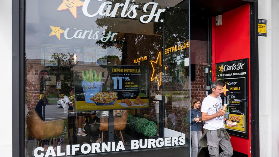 a customer walks out a carl's jr location