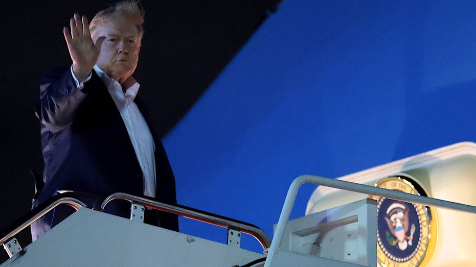 president donald trump waves before entering air force one