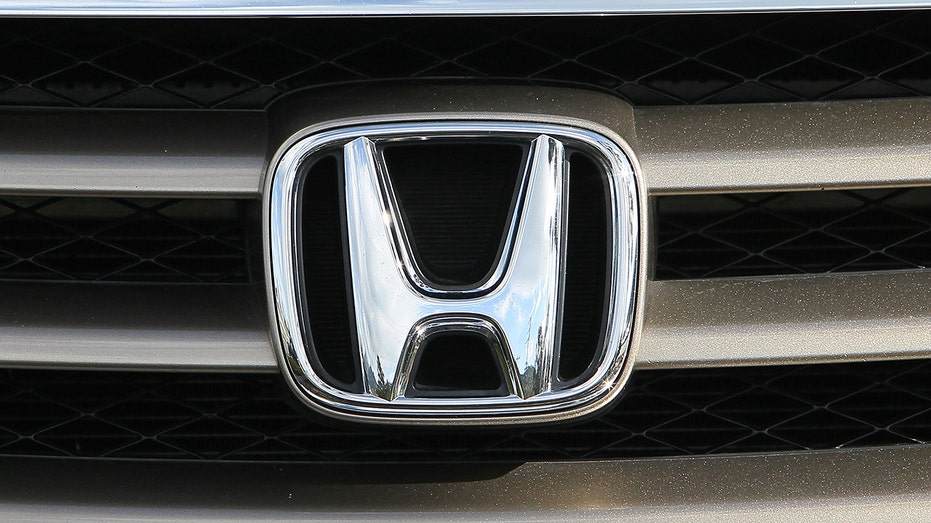The Honda logo is seen on the grill of a Honda mini van