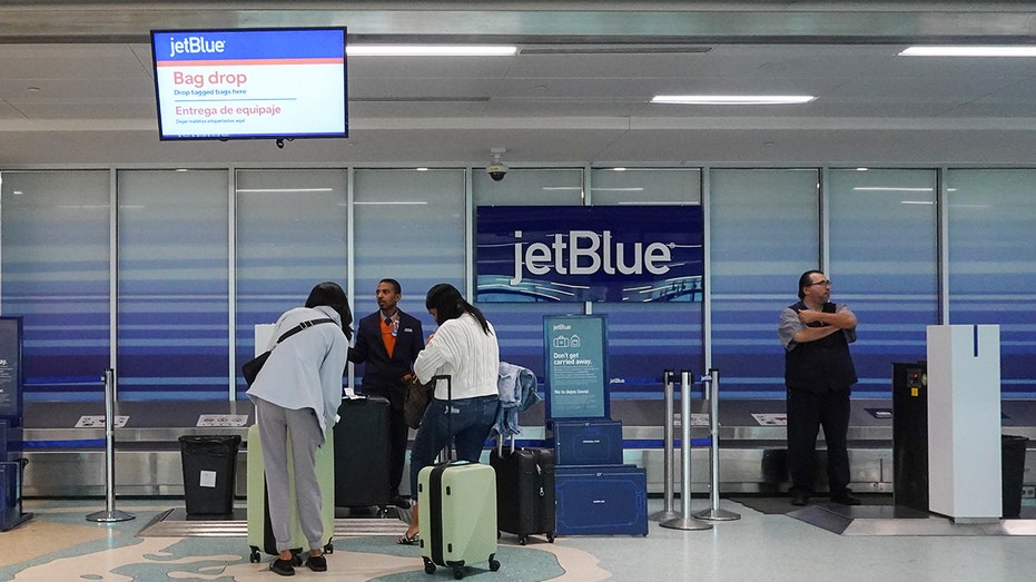 People check in their bags at the JetBlue Airways counter at Fort Lauderdale-Hollywood International Airport