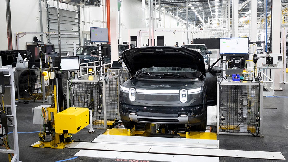 A Rivian R2 undergoing inspection on the assembly line