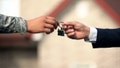 A service member receives house keys from a real estate professional. VA-backed mortgages are becoming more common as high housing costs push eligible military buyers to seek lower upfront costs. - Fox News