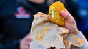 Person holds Taco Bell taco