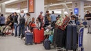 Delta Airlines passengers seen waiting to retrieve their luggage after flight cancelations at  La Guardia Airport on July 18, 2026.  - Fox Business News