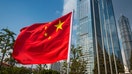 The vibrant red field and yellow stars of the Flag of the People's Republic of China flying in the breeze beside the futuristic glass and steel towers of Pudong's soaring skyscrapers, Shanghai, China. ProPhoto RGB profile for maximum color fidelity and gamut. - Fox Business News