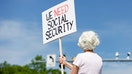 A woman holds a sign in support of Social Security Administration workers on Security Boulevard in front of the agency's headquarters in Woodlawn, Maryland. - Fox Business News