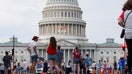 WASHINGTON, DC - JULY 4: Visitors stand outside of the grounds of the U.S. Capitol building after the area was closed due to high winds on July 4, 2026 in Washington, DC. Officials with Freedom 250 Salute to America issued a shelter in place order for an incoming thunderstorm and earlier the day the National Weather Service issued an Extreme Heat Warning for the region. - Fox Business News