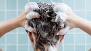 A woman shampooing her hair in the shower. - Fox Business News