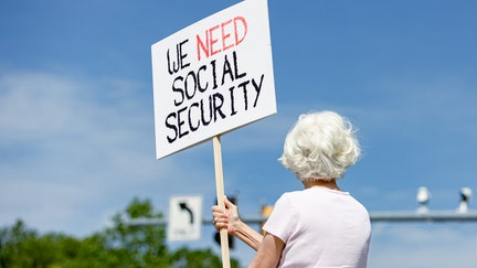 A woman holds a sign in support of Social Security Administration workers on Security Boulevard in front of the agency's headquarters in Woodlawn, Maryland. - Fox Business News
