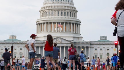 WASHINGTON, DC - JULY 4: Visitors stand outside of the grounds of the U.S. Capitol building after the area was closed due to high winds on July 4, 2026 in Washington, DC. Officials with Freedom 250 Salute to America issued a shelter in place order for an incoming thunderstorm and earlier the day the National Weather Service issued an Extreme Heat Warning for the region. - Fox Business News