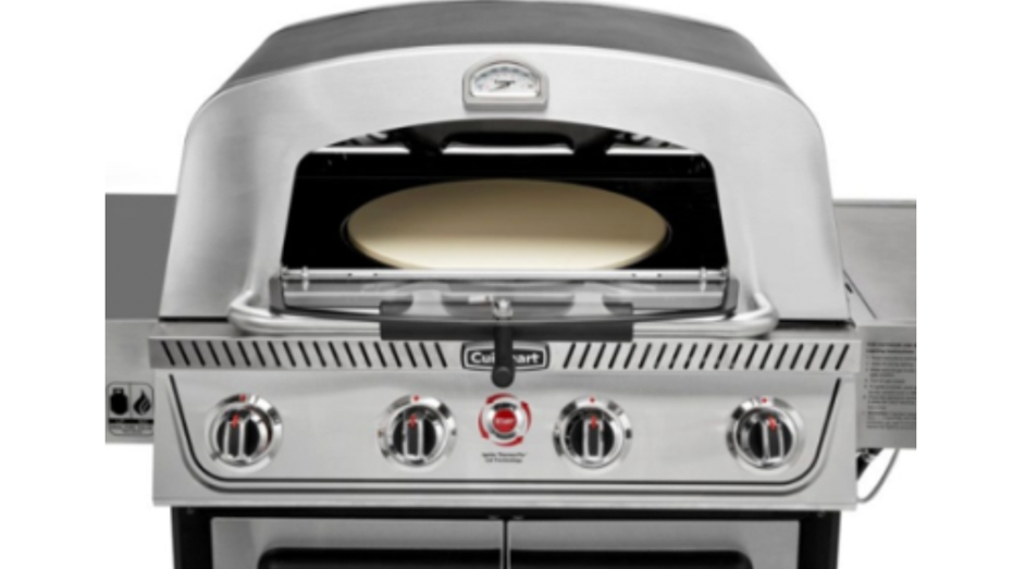 Closing the stainless steel grill with the lid open, revealing the pizza stone inside the cooking chamber.