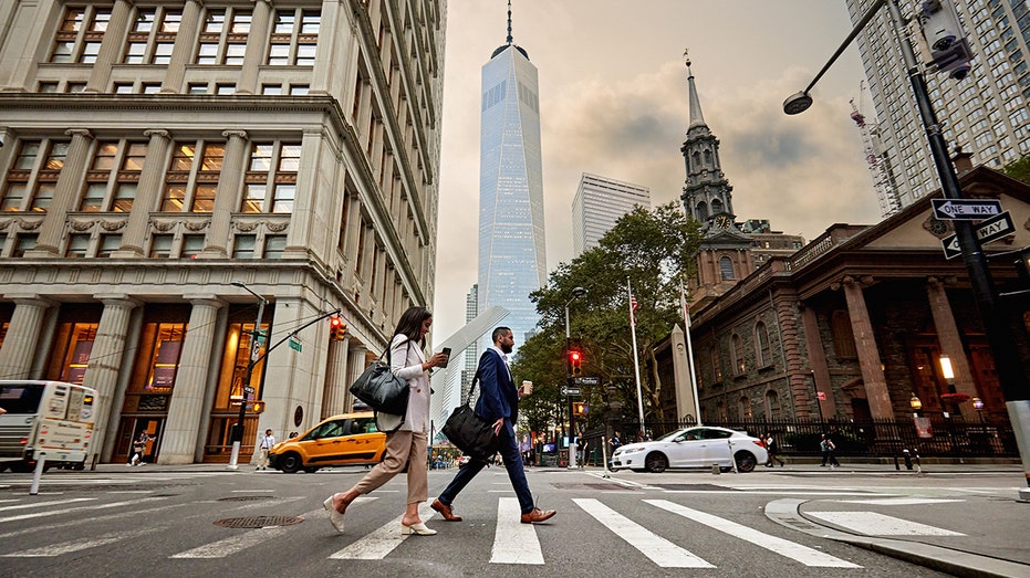 Business people crossing Fulton Street