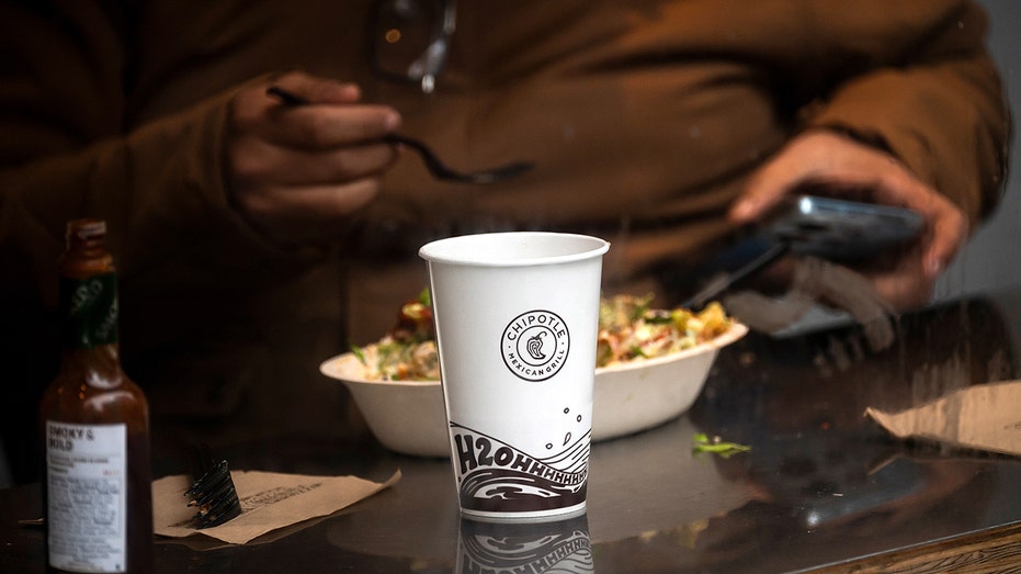 A customer dines inside a Chipotle restaurant