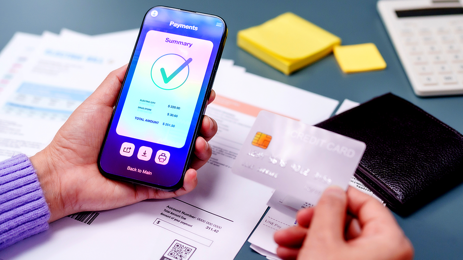 Woman using a smartphone to pay bills online.