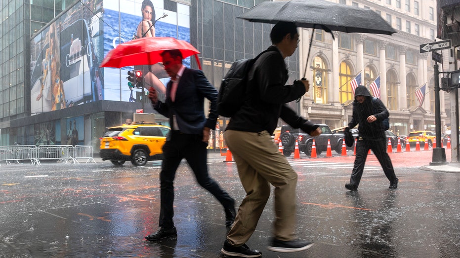 people walk in nyc during rain