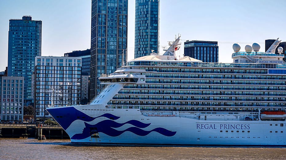 Regal Princess docked with skyscrapers in the background