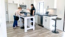 A real estate agent talks with a client in a house.