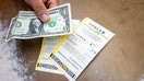 In this photo illustration, a clerk displays Powerball lottery tickets at a convenience store on December 19, 2025 in Austin, Texas. - Fox Business News