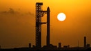 The Starship spacecraft and the Super Heavy v3 booster stand at Pad 2 at sunrise as preparations continue to launch its 13th test flight in Starbase, Texas, U.S., July 24, 2026.  - Fox Business News
