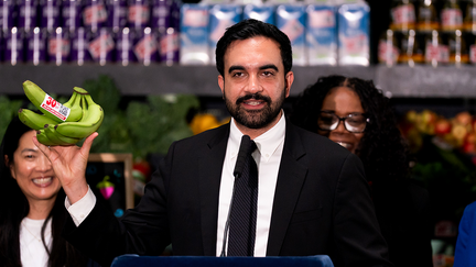 NYC Mayor Zohran Mamdani, mayor of New York, holds up bananas labeled with a 30% off sticker during an announcement on municipal grocery stores. - Fox Business News