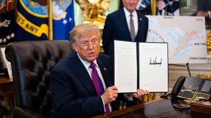 US President Donald Trump displays a signed executive order in the Oval Office of the White House in Washington, DC, US, on Thursday, Aug. 27, 2026. - Fox Business News