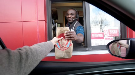 Store manager Kwame Poku serves food through the drive-thru window at a new Wendy&rsquo;s restaurant in Powell, Ohio, a suburb of Columbus. The restaurant chain is headquartered in another Columbus suburb, Dublin. - Fox Business News