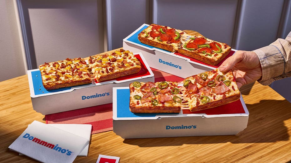 Domino’s new Detroit-style Domino pizzas with several topping combinations displayed in branded boxes