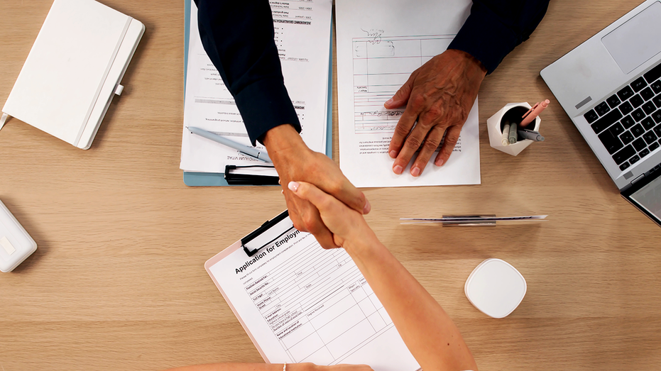 Shaking hands after job acceptance.