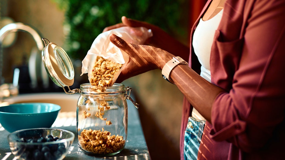 Woman pouring granola
