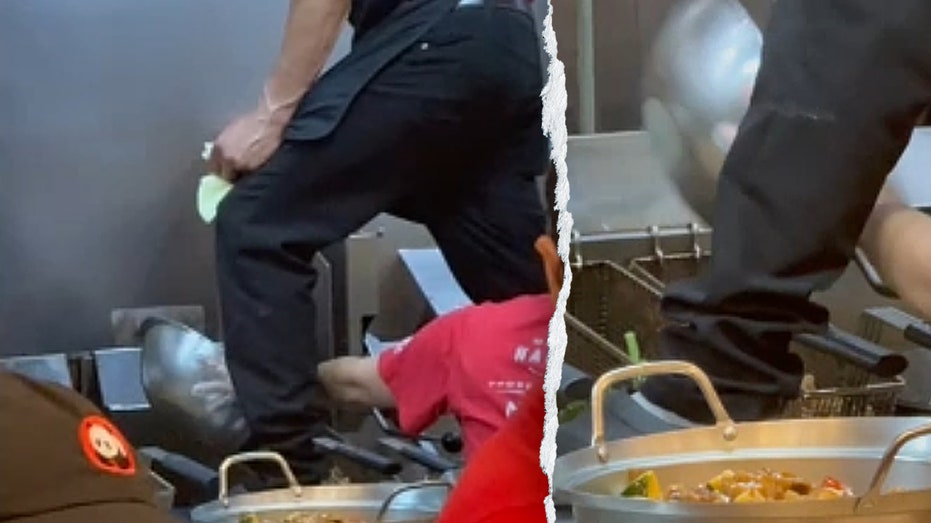 Panda Express worker stands on counter near fryer while cleaning