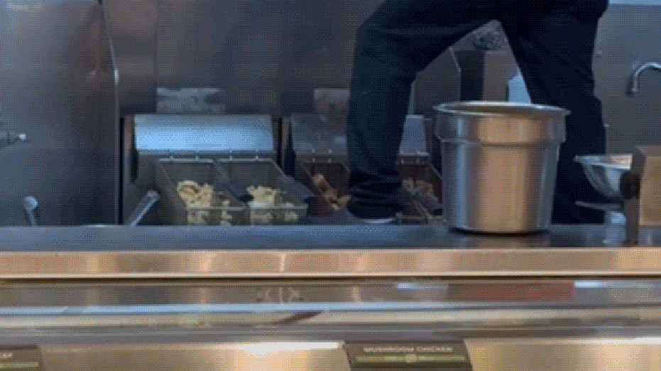 Panda Express worker seen standing near food inside restaurant