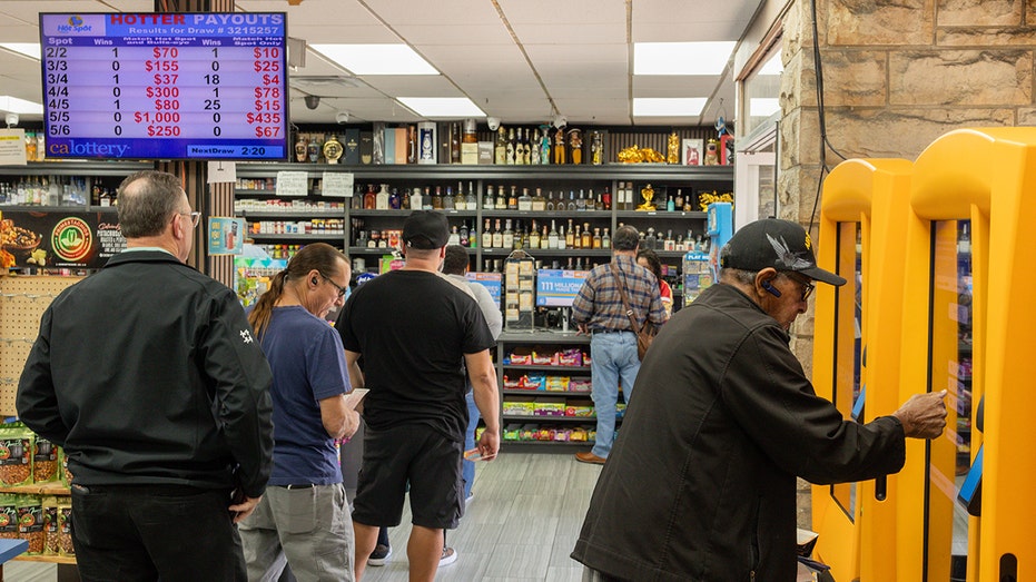 Customers wait in line to purchase lottery tickets