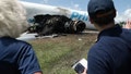 Officials inspect the charred engine assembly on the side of the Amazon Prime Air fuselage. - Fox News